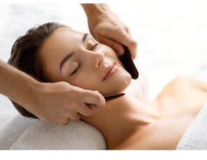 A woman receives an enzyme facial in a spa setting