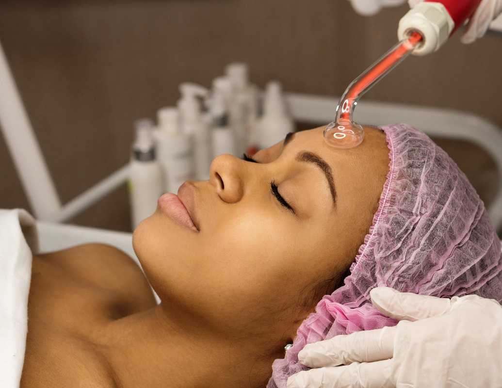 A woman in a spa receiving a microdermabrasion facial