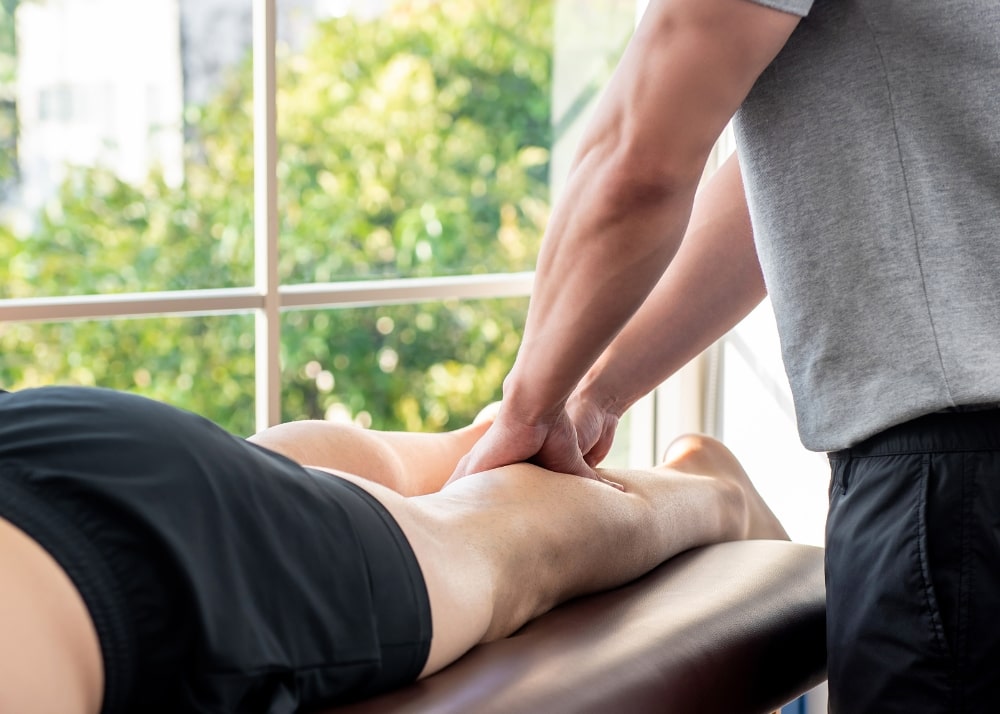 A picture of a man receiving sports massage therapy on his calf muscles