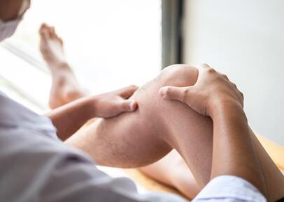 A picture of a man receiving clinical massage therapy on his leg