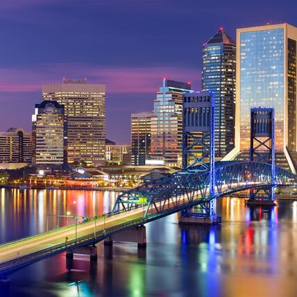 An image of city lights over a river (downtown Jacksonville, FL at night)