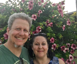 A photo of Ronnie Yocham and Kendra Lay against a flowered backdrop