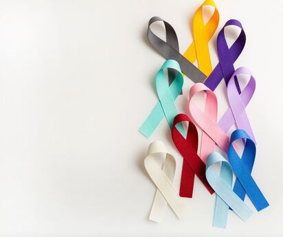 Several ribbons in different colors again a white background, representing cancer awareness