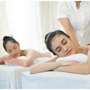 Two woman looking peaceful and receiving a couples massage
